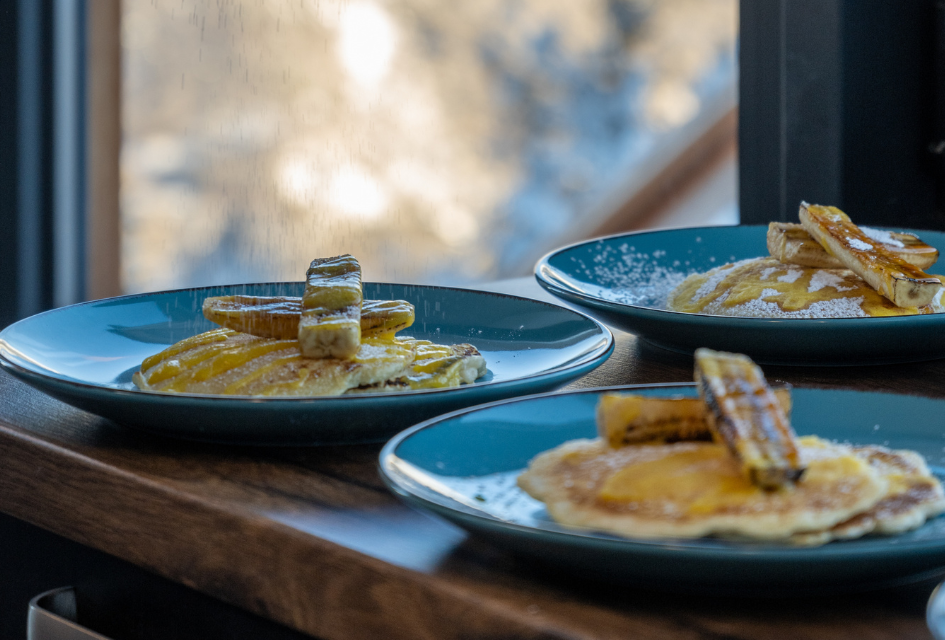 Gourmet breakfast at Chalet 3Sixty in La Tania - pancakes and bananas with a syrup and dusted sugar. A great start to the day on a luxury catered ski holiday in France.