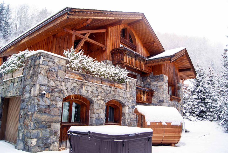 External of Chalet Etienne, showcasing the outdoor hot tub and barrel sauna. 