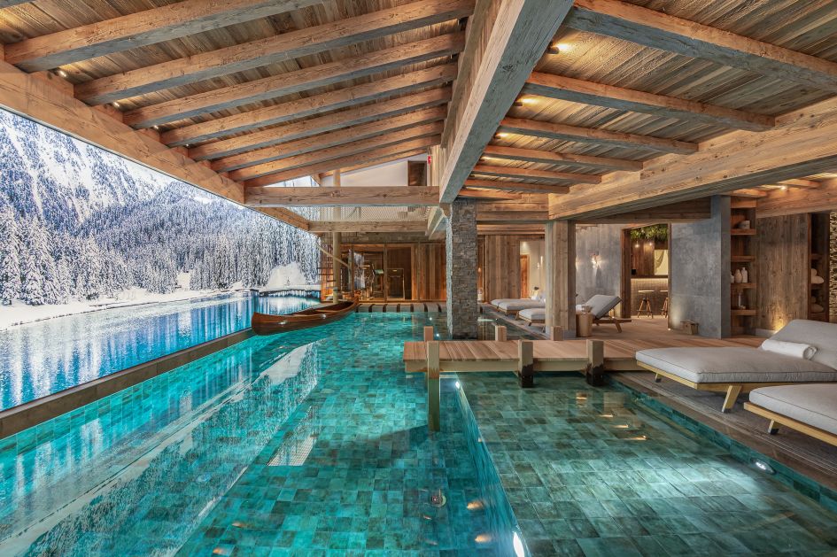 The luxurious indoor swimming pool and loungers of Chalet Bruxellois, one of the best family ski chalets in the Three Valleys.