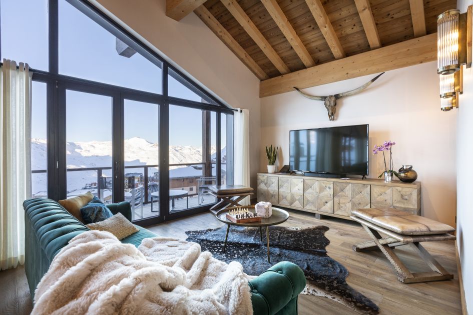 Living room with large windows framing the mountain view at Chalet Golden Jubilee