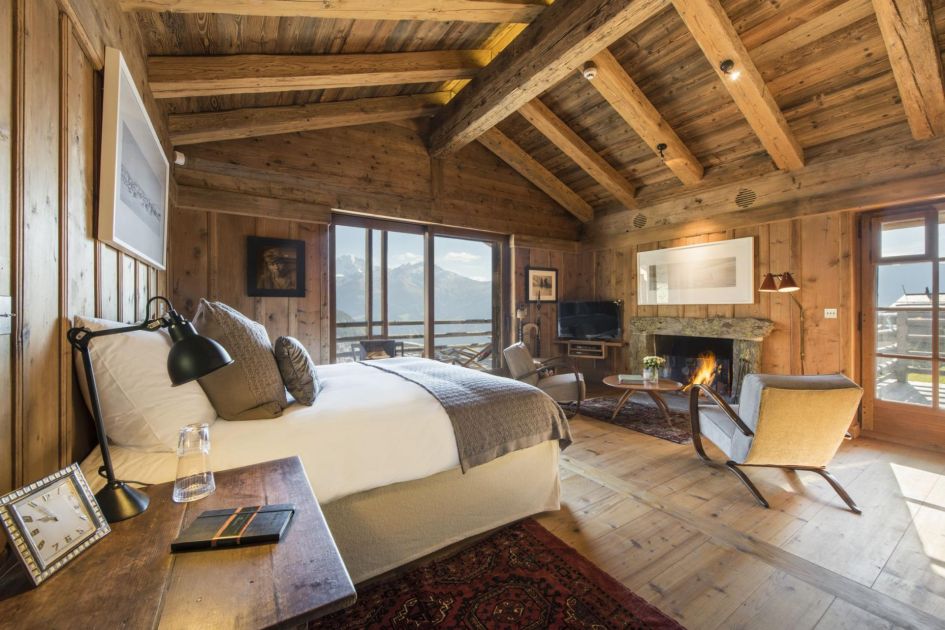 the master bedroom with an open fireplace at Chalet Orsini
