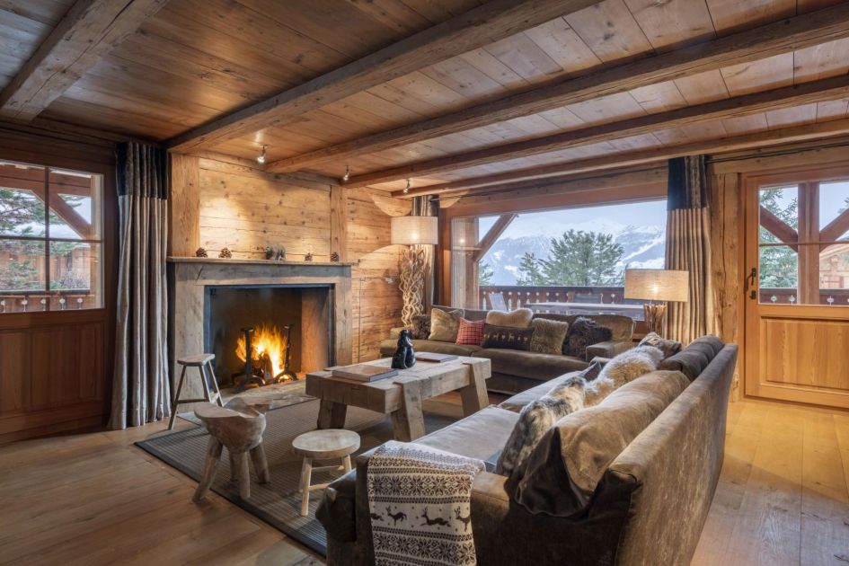 The cosy living room at Apartment La Dranse 111 with an open fireplace and convivial furnishings