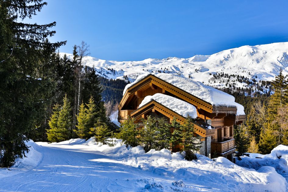 The external view of Chalet Trois Ours with picturesque mountains in the background 