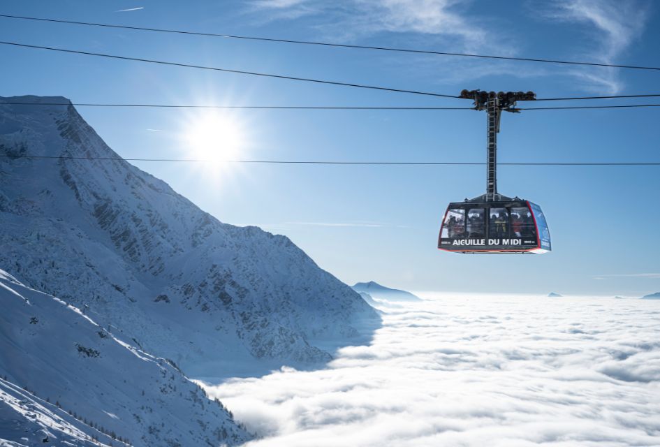 The Aiguille du Midi cable car above the clouds and the Mont Blanc Massif. One of the top things to do in Chamonix for non-skiers!