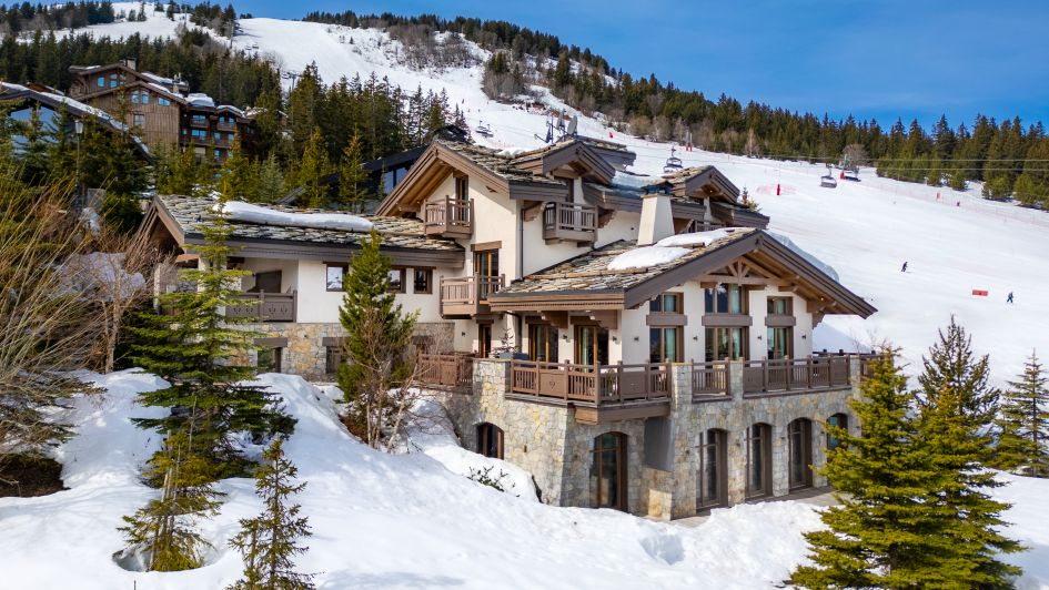 The external view of Shemshak Lodge positioned to the right of the Dou du Midi piste