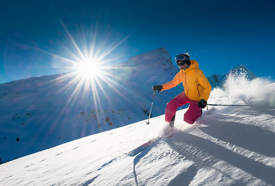 Enjoying a blue bird ski day with the sun shining on a Telemark skiing holiday.