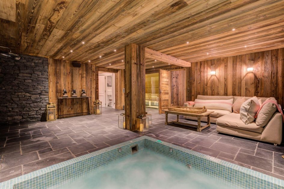 The Lightbowne's serene wellness area has a sunken indoor Jacuzzi, side lounge seating and a sauna at the back. Wooden cladding and mood lighting create an inviting setting.