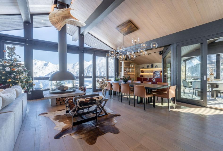 The stunning living area of this ski-in, ski-out chalet in Courchevel: Chalet B, with mountain views from the large windows.