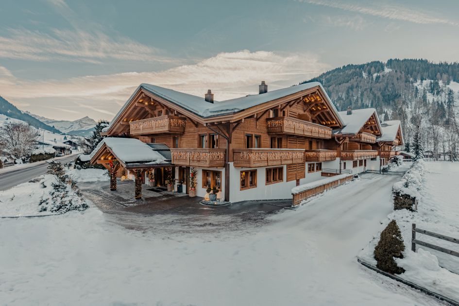 Wooden and white facade of the Ultima Gstaad Hotel's exterior - perfect for hosting those luxury ski holidays in Gstaad.