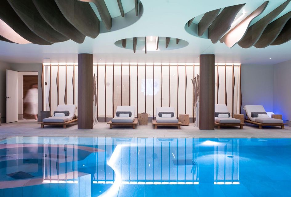 Indoor pool at Six Senses Courchevel 1850's beautiful spa area, that is worthy of being on the list of the best mountain spas. Loungers alongside and creative decor.