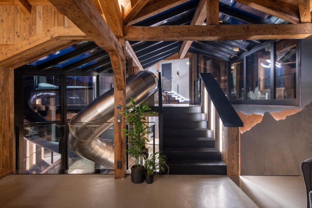 Interior shot of Chalet Tataali with the indoor slide by the staircase pictured from the hallway