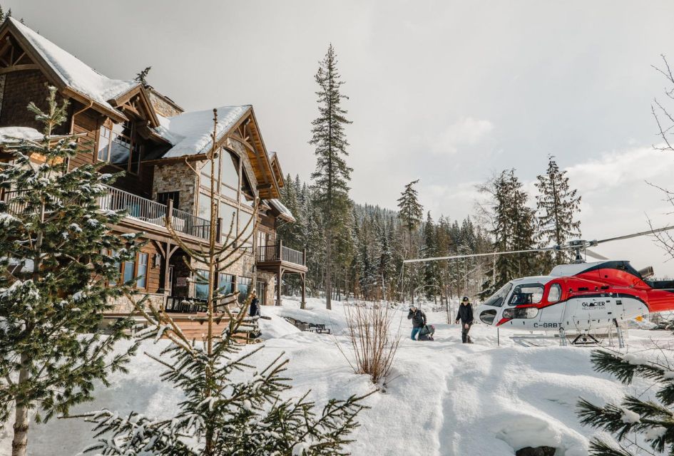 Exterior of Bison Lodge, Revelstoke, one of the top luxury lodges in Canada, with stationary helicopter alongside.