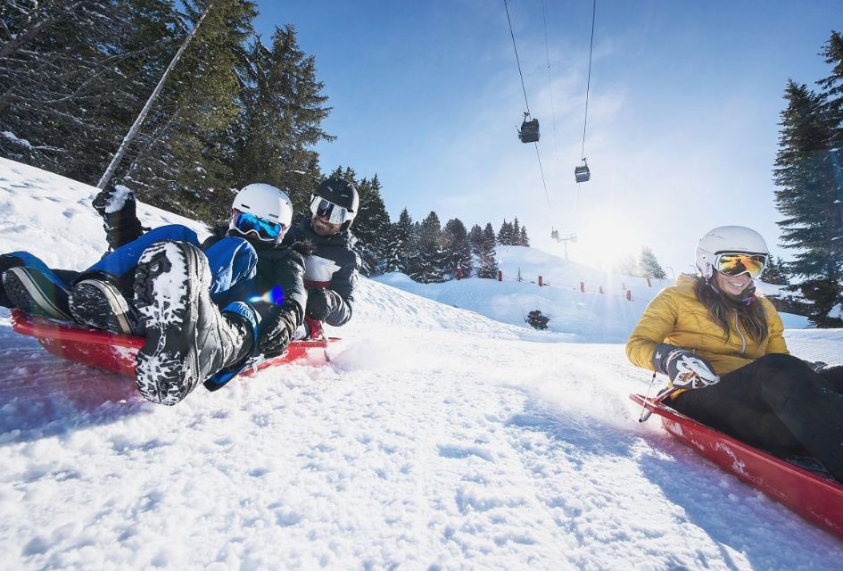 Three people on a family toboggan run in Courchevel Moriond, a great activity featured on our guide to Courchevel.