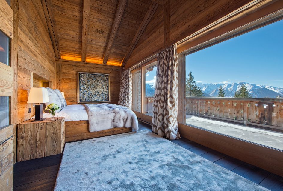 Inside the bright master bedroom of Chalet Makini looking over the Verbier Valley.