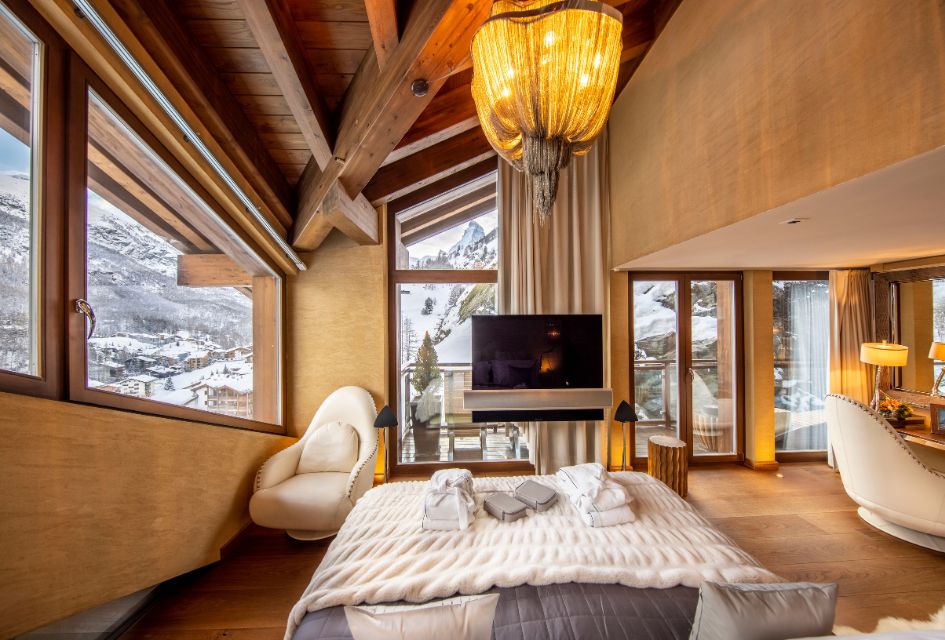 Inside the luxury chalet bedroom of Chalet Zermatt Peak, looking out towards the peak of the Matterhorn.